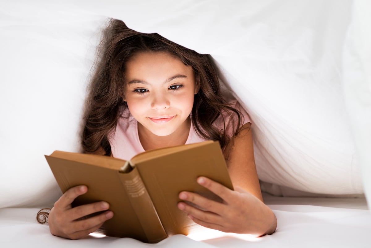 front-view-cute-little-girl-reading