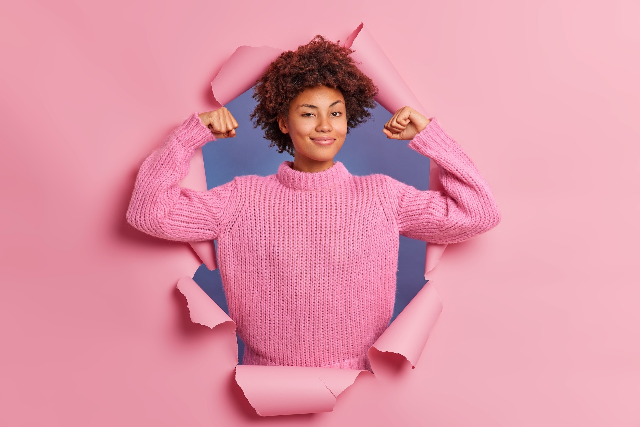 self-assured-beautiful-young-afro-american-woman-raises-arms-shows-biceps-being-strong-powerful